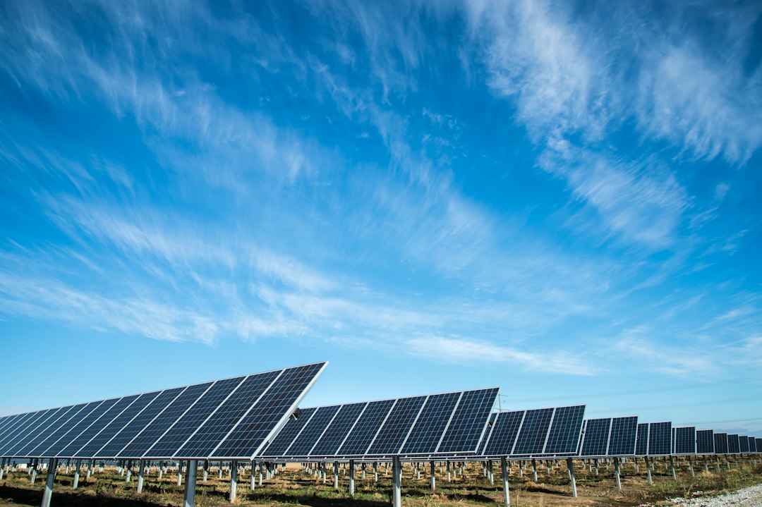 Rows of photovoltaic panels beneath a blue sky